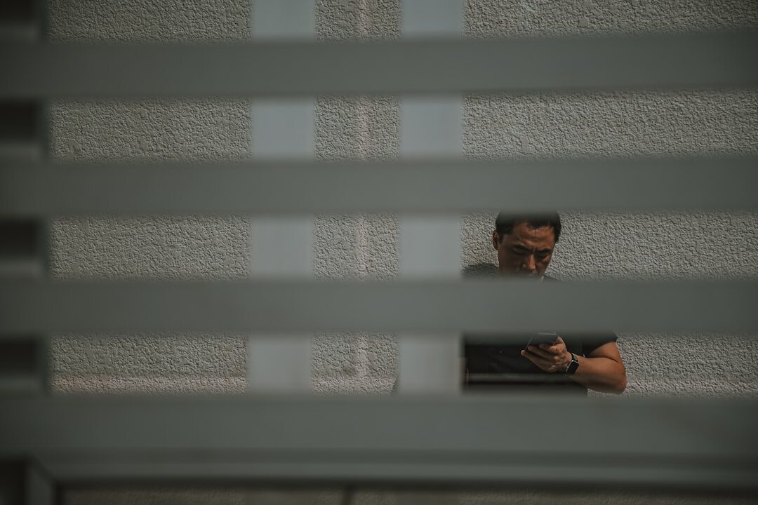Brazilian young man writing in a journal by a window